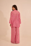 Back view of the one-size pink striped crochet poncho, illustrating its drape and versatility.