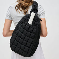 Sol and Selene Quilted Puffer Sling Backpack in black nylon with quilted design, adjustable strap, and zippered compartments.