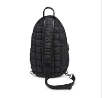 Sol and Selene Quilted Puffer Sling Backpack in black nylon with quilted design, adjustable strap, and zippered compartments.